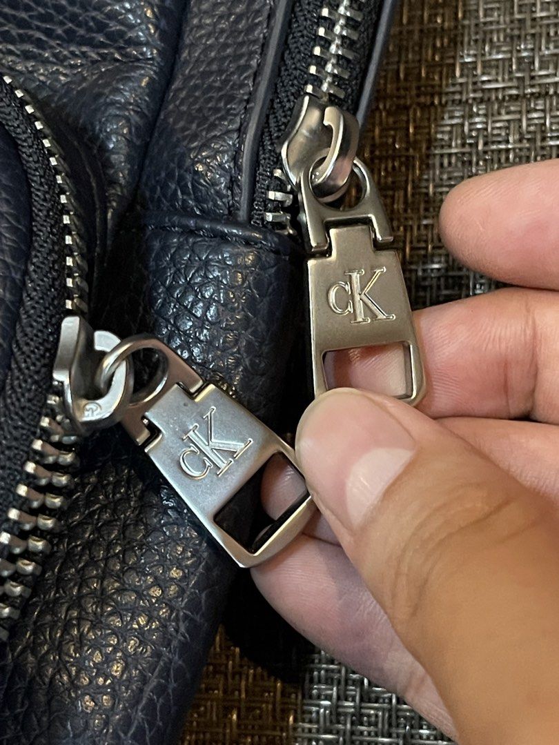 Calvin Klein Blue Leather Large Body Bag (Category: Backpacks) located in Quezon City. Submitted by mimi_declutters (Listing ID 1431404314, Image 2). Description: - Brand new Calvin Klein backpack - Color: Navy blue - Features: - Front pocket - Main compartment - CK logo zippers - Mesh back panel - Calvin Klein branded strap - Includes original tag with $129.50 price - AUTHENTICITY GUARANTEED SLIGHTLY NEGOTIABLE.