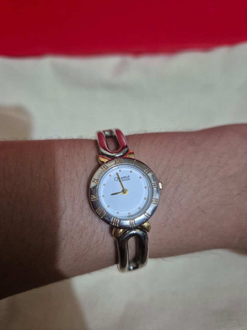 Caravelle Ladies Watch (Category: Women's Watches) located in Manila. Submitted by PIT2007 (Listing ID 1431512445, Image 2). Description: - Caravelle ladies watch - Silver and gold-tone design - White dial with Roman numeral hour markers - Gold-tone hands - Unique bracelet-style band - Silver, gold, and red accents - Quartz - Stylish accessory for everyday wear.