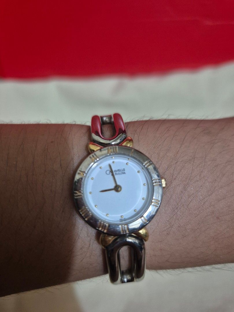 Caravelle Ladies Watch (Category: Women's Watches) located in Manila. Submitted by PIT2007 (Listing ID 1431512445, Image 1). Description: - Caravelle ladies watch - Silver and gold-tone design - White dial with Roman numeral hour markers - Gold-tone hands - Unique bracelet-style band - Silver, gold, and red accents - Quartz - Stylish accessory for everyday wear.