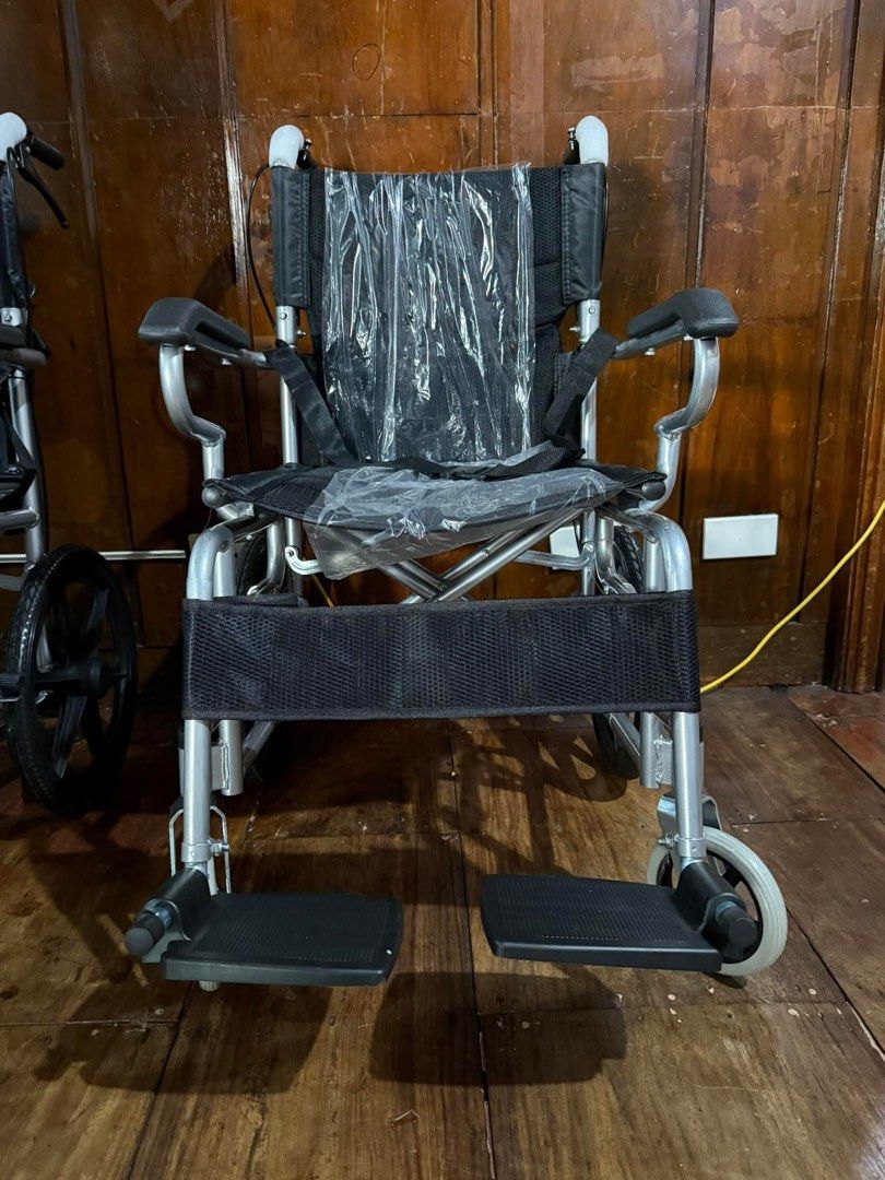 Cart type Travel Wheelchair (Category: Wheelchairs) located in Manila. Submitted by rosel2001 (Listing ID 1431415708, Image 3). Description: - Cart type Travel Wheelchair - Lightweight and foldable design - Features footrests and armrests - Includes a safety strap - Available in blue or black seat - Durable silver frame.