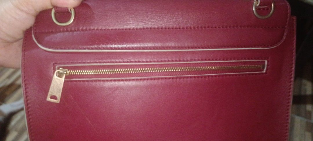 Celine Burgundy Leather Handbag (Category: Luxury Bags & Wallets) located in Legazpi City. Submitted by georgepineda791 (Listing ID 1431479077, Image 3). Description: - Preloved Celine handbag - Burgundy leather exterior - Gold-tone clasp - Top handle - Lighter burgundy interior with zipper pocket - Blue interior lining - "Celine" and "Made in Italy" markings - Made in Italy.
