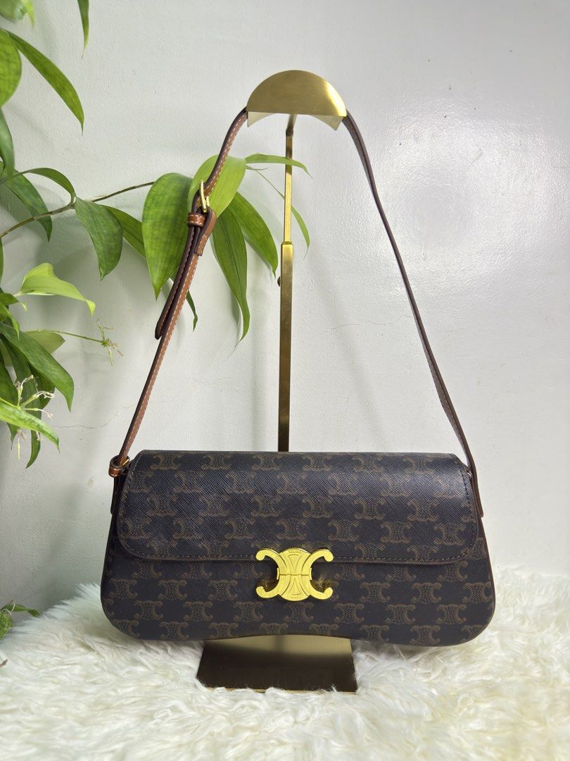 Celine Triomphe Shoulder Bag (Category: Luxury Bags & Wallets) located in Consolacion. Submitted by naome1. (Listing ID 1431482672, Image 1). Description: - Celine Triomphe shoulder bag - Iconic Triomphe clasp - Brown monogram pattern - Brown leather strap - Gold-tone hardware - Brown leather interior - Celine Paris logo - Serial number: SP2175.