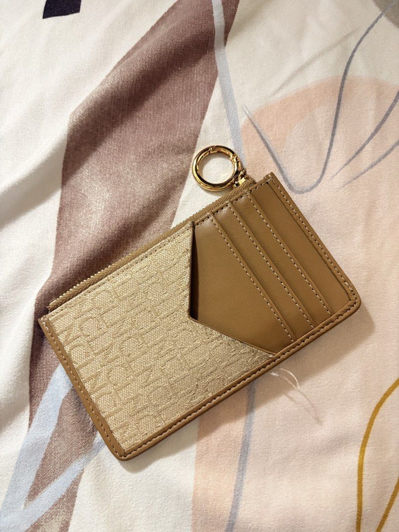 CLN cardholder and purse (Category: Luxury Bags & Wallets) located in Manila. Submitted by alejaoe (Listing ID 1431388636, Image 2). Description: Elevate your daily essentials with this stunning CLN monogram cardholder. Designed for the woman on the go who loves a mix of neutral tones and gold hardware. Compact enough for your smallest mini-bag, but stylish enough to carry on its own. • Color: Sand/Beige with Gold Accents • Features: Multiple car