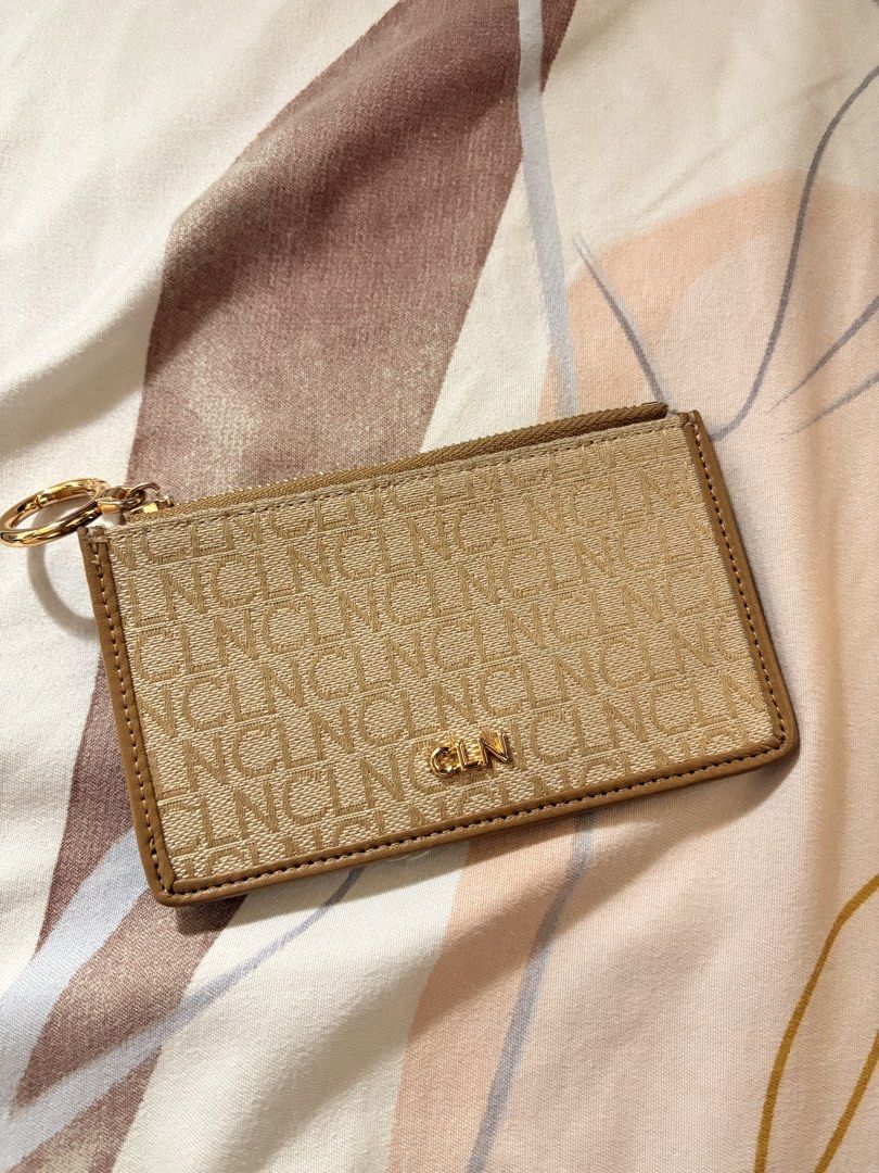 CLN cardholder and purse (Category: Luxury Bags & Wallets) located in Manila. Submitted by alejaoe (Listing ID 1431388636, Image 1). Description: Elevate your daily essentials with this stunning CLN monogram cardholder. Designed for the woman on the go who loves a mix of neutral tones and gold hardware. Compact enough for your smallest mini-bag, but stylish enough to carry on its own. • Color: Sand/Beige with Gold Accents • Features: Multiple car