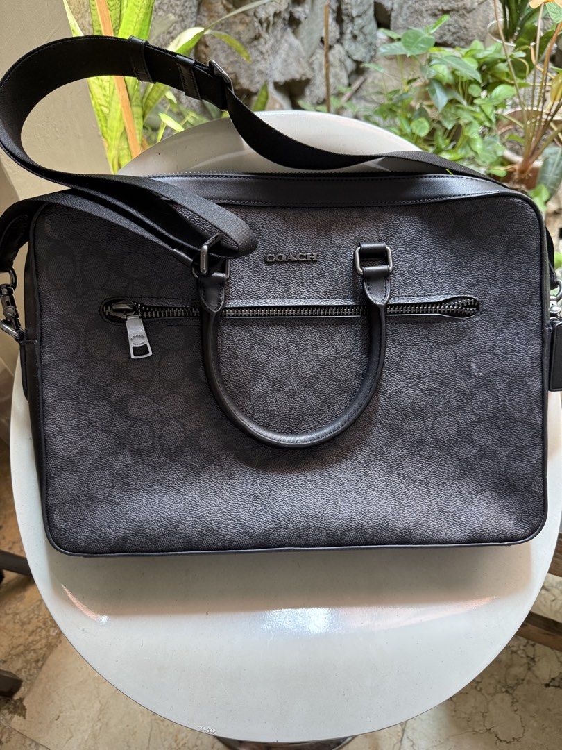 Coach Ethan Slim Brief Sig (Category: Shoulder Bags) located in Manila. Submitted by declutter_with_cmb (Listing ID 1431394814, Image 1). Description: - Coach Ethan Slim Brief in charcoal/black - Zip closure - Interior laptop compartment - Multiple pockets for organization - Detachable strap for shoulder or crossbody wear - Made in Vietnam - Style number: CV917 - Comparable value: $550 USD / $670 CAD.
