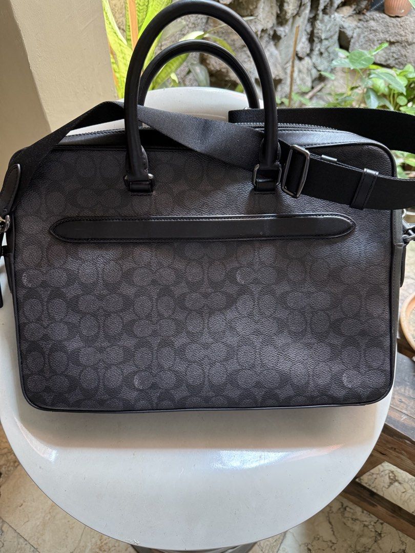 Coach Ethan Slim Brief Sig (Category: Shoulder Bags) located in Manila. Submitted by declutter_with_cmb (Listing ID 1431394814, Image 2). Description: - Coach Ethan Slim Brief in charcoal/black - Zip closure - Interior laptop compartment - Multiple pockets for organization - Detachable strap for shoulder or crossbody wear - Made in Vietnam - Style number: CV917 - Comparable value: $550 USD / $670 CAD.