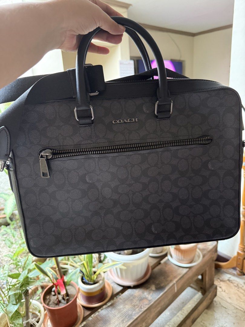 Coach Ethan Slim Brief Sig (Category: Shoulder Bags) located in Manila. Submitted by declutter_with_cmb (Listing ID 1431394814, Image 3). Description: - Coach Ethan Slim Brief in charcoal/black - Zip closure - Interior laptop compartment - Multiple pockets for organization - Detachable strap for shoulder or crossbody wear - Made in Vietnam - Style number: CV917 - Comparable value: $550 USD / $670 CAD.