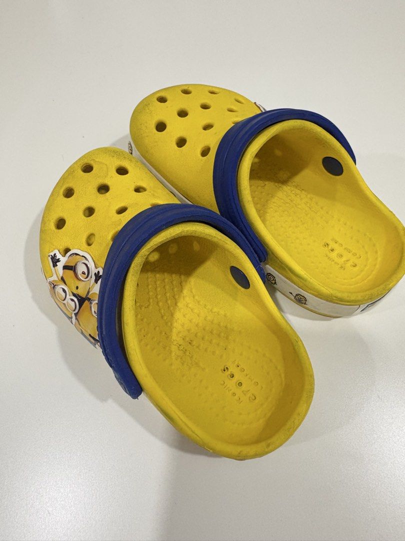 Crocs Minions Clog Shoes Size C6 (Category: Babies & Kids Fashion) located in Manila. Submitted by analyntorr16083 (Listing ID 1431480642, Image 2). Description: - Yellow Crocs clogs with Minions design - Size: C6 - Features a blue strap and white border - Multiple ventilation holes - Authentic Crocs logo on sole.