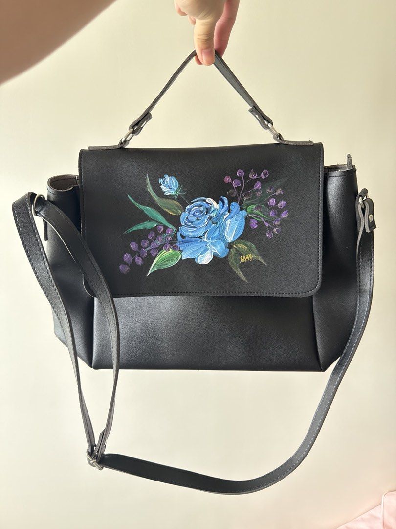 Custom Black Handbag with Top Handle (Category: Luxury Bags & Wallets) located in Quezon City. Submitted by mariellaangela (Listing ID 1431475943, Image 1). Description: - Black handbag - Top handle and shoulder strap - Flap closure - Shows wear and tear on edges - Made of a leather-like material.