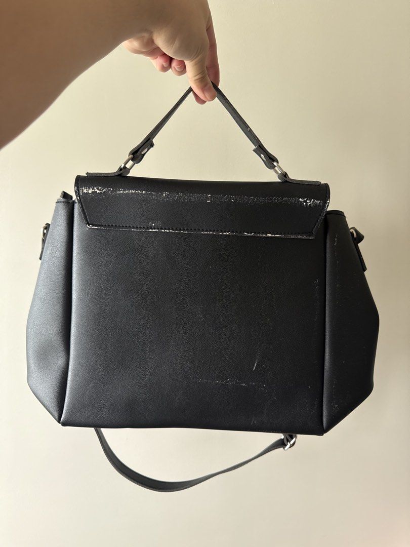Custom Black Handbag with Top Handle (Category: Luxury Bags & Wallets) located in Quezon City. Submitted by mariellaangela (Listing ID 1431475943, Image 3). Description: - Black handbag - Top handle and shoulder strap - Flap closure - Shows wear and tear on edges - Made of a leather-like material.