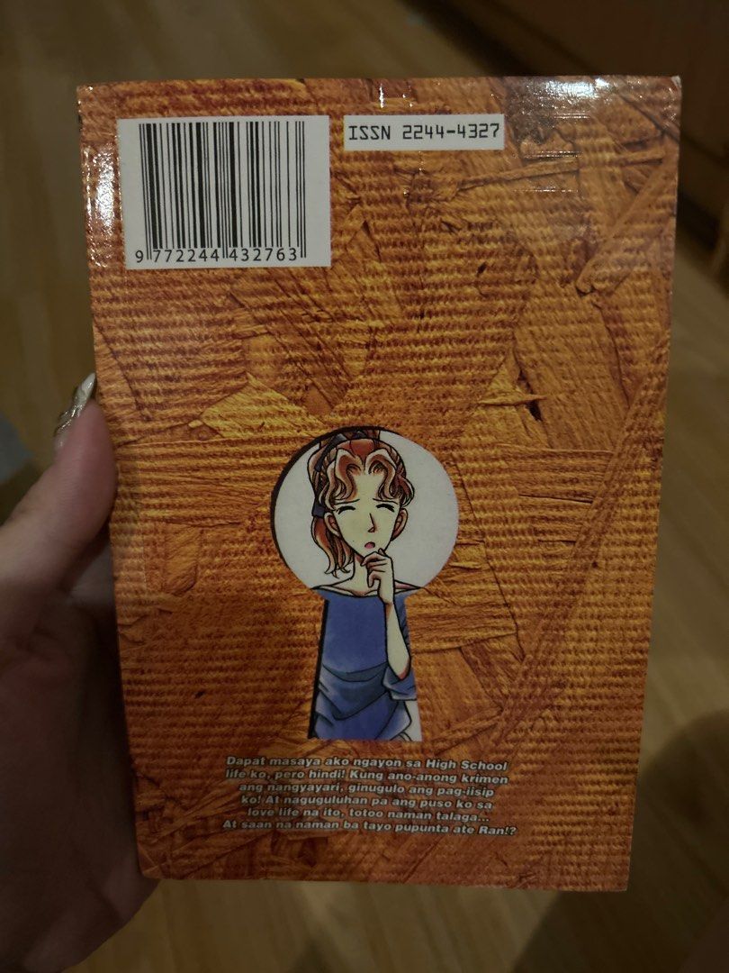 Detective Conan Volume 13 (Category: Comics & Manga) located in Quezon City. Submitted by bmswardrobe (Listing ID 1431528312, Image 2). Description: - Detective Conan Volume 13 manga - Features Detective Conan on the cover - Contains illustrations and text in Filipino - Published by Jline Comics Center - Includes barcode and keyhole design on the back cover - Ideal for Detective Conan fans.