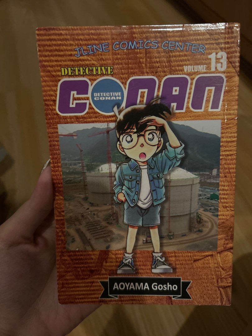 Detective Conan Volume 13 (Category: Comics & Manga) located in Quezon City. Submitted by bmswardrobe (Listing ID 1431528312, Image 1). Description: - Detective Conan Volume 13 manga - Features Detective Conan on the cover - Contains illustrations and text in Filipino - Published by Jline Comics Center - Includes barcode and keyhole design on the back cover - Ideal for Detective Conan fans.
