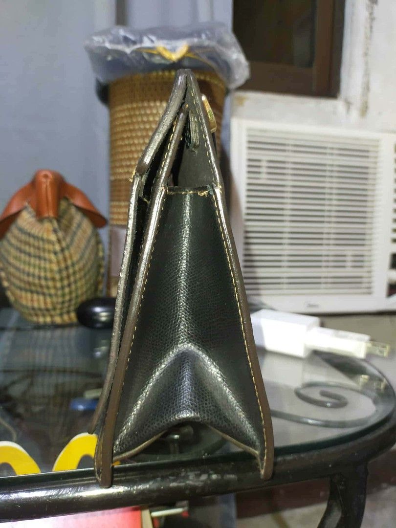 Furla Black Leather Handbag (Category: Luxury Bags & Wallets) located in Manila. Submitted by cvntyy (Listing ID 1431436745, Image 3). Description: - Authentic Furla handbag - Black color - Top handle and detachable shoulder strap - Rectangular shape - Textured leather exterior - Gold-tone hardware - Flap closure - Spacious interior - Versatile design helping a friend!! .
