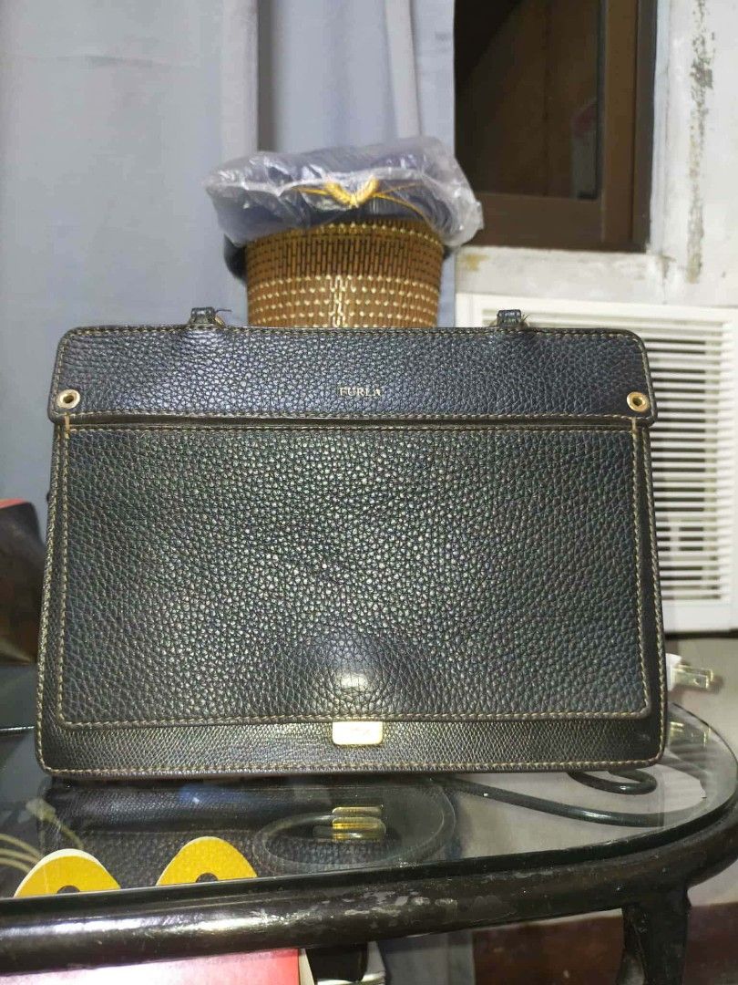 Furla Black Leather Handbag (Category: Luxury Bags & Wallets) located in Manila. Submitted by cvntyy (Listing ID 1431436745, Image 2). Description: - Authentic Furla handbag - Black color - Top handle and detachable shoulder strap - Rectangular shape - Textured leather exterior - Gold-tone hardware - Flap closure - Spacious interior - Versatile design helping a friend!! .