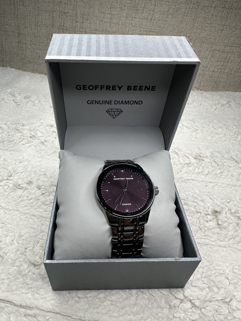 Geoffrey Beene Genuine Diamond Watch (Category: Men's Watches) located in Manila. Submitted by classywardrobemanila (Listing ID 1431443334, Image 1). Description: - Geoffrey Beene watch - Dark purple dial - Features a diamond accent - Comes with original box - Metal band - Classic design - Adds sophistication to any outfit.