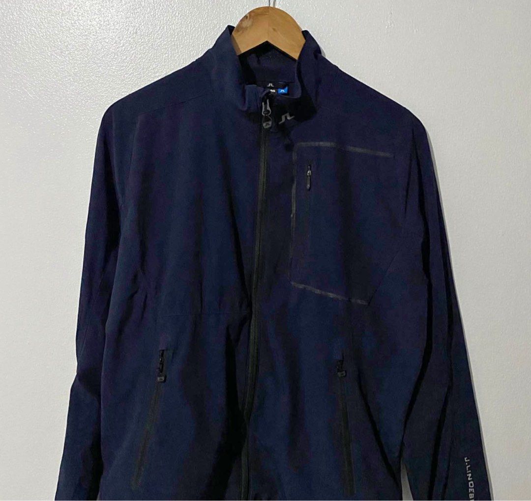 J. Lindeberg Navy Jacket (Category: Coats, Jackets and Outerwear) located in Manila. Submitted by takemystuffbuymystuff (Listing ID 1431422822, Image 1). Description: - J. Lindeberg navy blue jacket - Full zip closure - Multiple zip pockets - J. Lindeberg logo on back and collar - Stand-up collar - Made of polyester and elastane blend - Made in Vietnam.