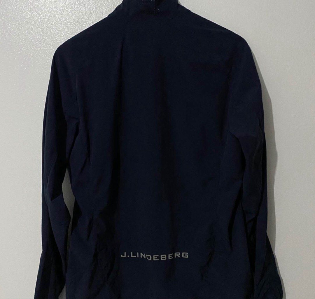 J. Lindeberg Navy Jacket (Category: Coats, Jackets and Outerwear) located in Manila. Submitted by takemystuffbuymystuff (Listing ID 1431422822, Image 3). Description: - J. Lindeberg navy blue jacket - Full zip closure - Multiple zip pockets - J. Lindeberg logo on back and collar - Stand-up collar - Made of polyester and elastane blend - Made in Vietnam.