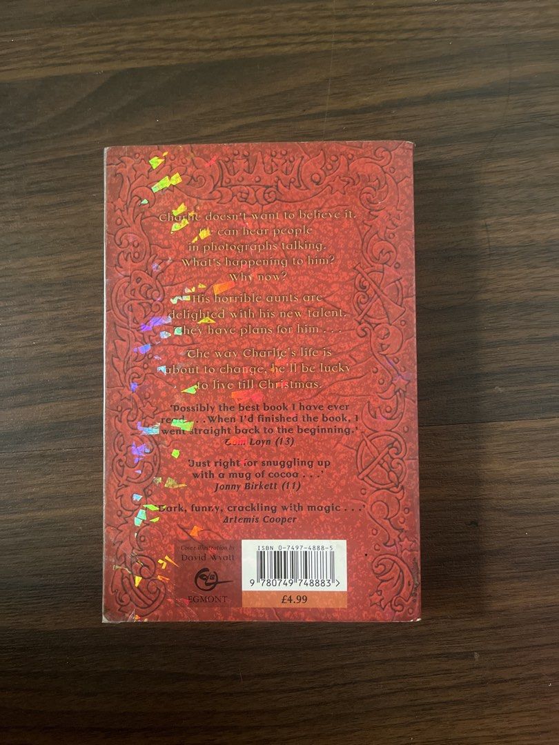 Midnight for Charlie Bone by Jenny Nimmo (Category: Storybooks) located in Manila. Submitted by dreyttd (Listing ID 1431462424, Image 2). Description: - "Midnight for Charlie Bone" by Jenny Nimmo - Red cover with fantasy illustration - Pre-owned condition - Visible wear on edges - Includes back cover quotes and price tag - Published by Orchard Books -Foxing and tanning -Minimal Spine creases -Has plastic Cover.