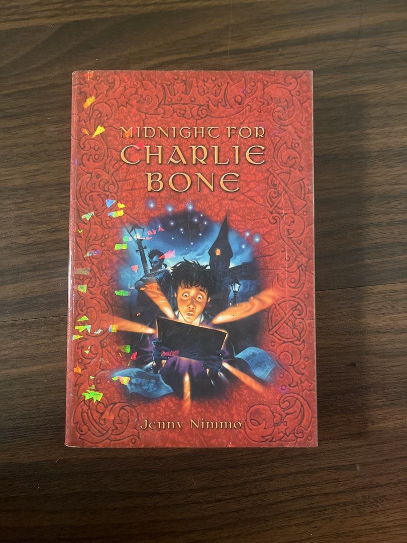 Midnight for Charlie Bone by Jenny Nimmo (Category: Storybooks) located in Manila. Submitted by dreyttd (Listing ID 1431462424, Image 1). Description: - "Midnight for Charlie Bone" by Jenny Nimmo - Red cover with fantasy illustration - Pre-owned condition - Visible wear on edges - Includes back cover quotes and price tag - Published by Orchard Books -Foxing and tanning -Minimal Spine creases -Has plastic Cover.
