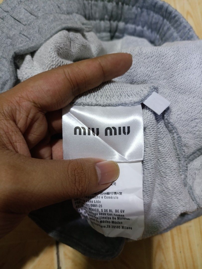 Miu Miu Club Shorts (Category: Shorts) located in Quezon City. Submitted by daniel_thrift05 (Listing ID 1431503569, Image 3). Description: - Gray Miu Miu shorts - Drawstring waist - Miu Miu Club logo on leg - Made in Italy - Size P - Two back pockets - Authentic with brand tag.