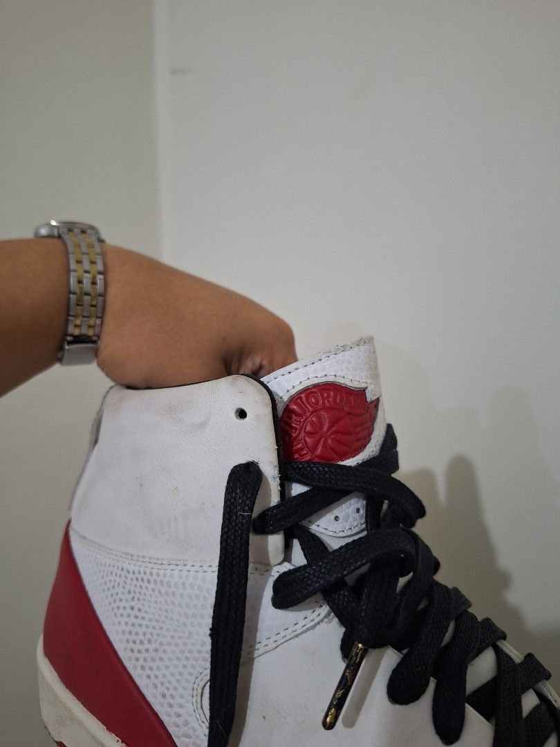 Nike Air Jordan 2 Retro High (Category: Sneakers) located in Makati City. Submitted by pengsuppp (Listing ID 1431569789, Image 2). Description: Nike Air Jordan 2 Women's SE Retro High sneakers - Colorway: White, Red, and Black - Features a white leather upper - Red accents on sole and heel - Black laces - Iconic Nike logo - Size: US 8.5 - Gift from my ate, and this was bought in Dubai - Original box and keychain is nasa bahay namin sa province, I