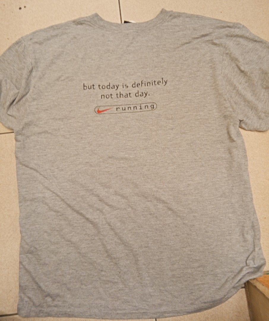 Nike Dri-FIT Running Tee (Category: Activewear) located in Lucban. Submitted by aeronroyyy (Listing ID 1431386990, Image 2). Description: - Nike Dri-FIT running t-shirt - Color: Gray - Size: M - Graphic: "someday you might be fast enough to beat me..." (front) and "but today is definitely not that day. running" (back) - Made in USA.