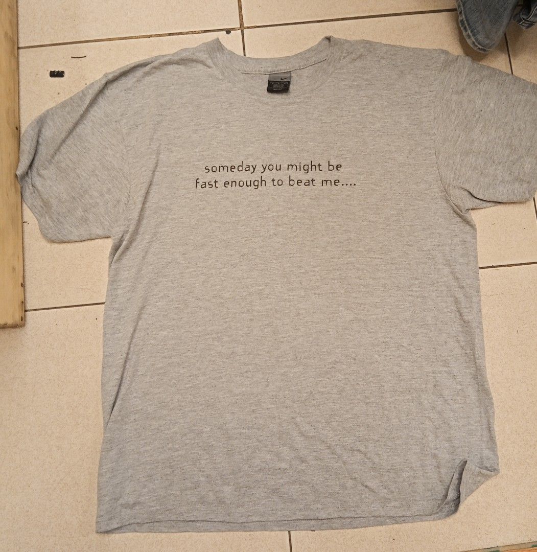 Nike Dri-FIT Running Tee (Category: Activewear) located in Lucban. Submitted by aeronroyyy (Listing ID 1431386990, Image 1). Description: - Nike Dri-FIT running t-shirt - Color: Gray - Size: M - Graphic: "someday you might be fast enough to beat me..." (front) and "but today is definitely not that day. running" (back) - Made in USA.