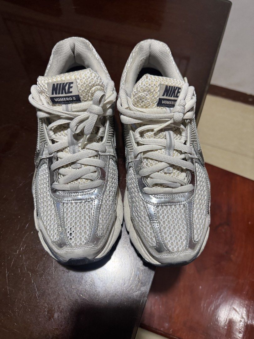 Nike Vomero 5 Photon Dust Metallic Silver (Category: Sneakers) located in Quezon City. Submitted by rg1996 (Listing ID 1431504918, Image 3). Description: Size 9 mens (10.5 women on tag) With original box Small hole on right toe (see last pic).