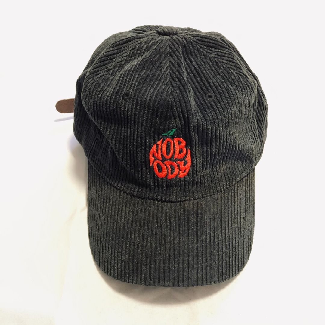 NOBODY - black corduroy baseball cap (Category: Caps & Hats) located in Rizal. Submitted by sensorix___ (Listing ID 1431437777, Image 1). Description: black corduroy baseball cap features a red embroidered apple-shaped logo on the front with the word "NOBODY" OSFA - One size fits all if you interested please just hit the message..