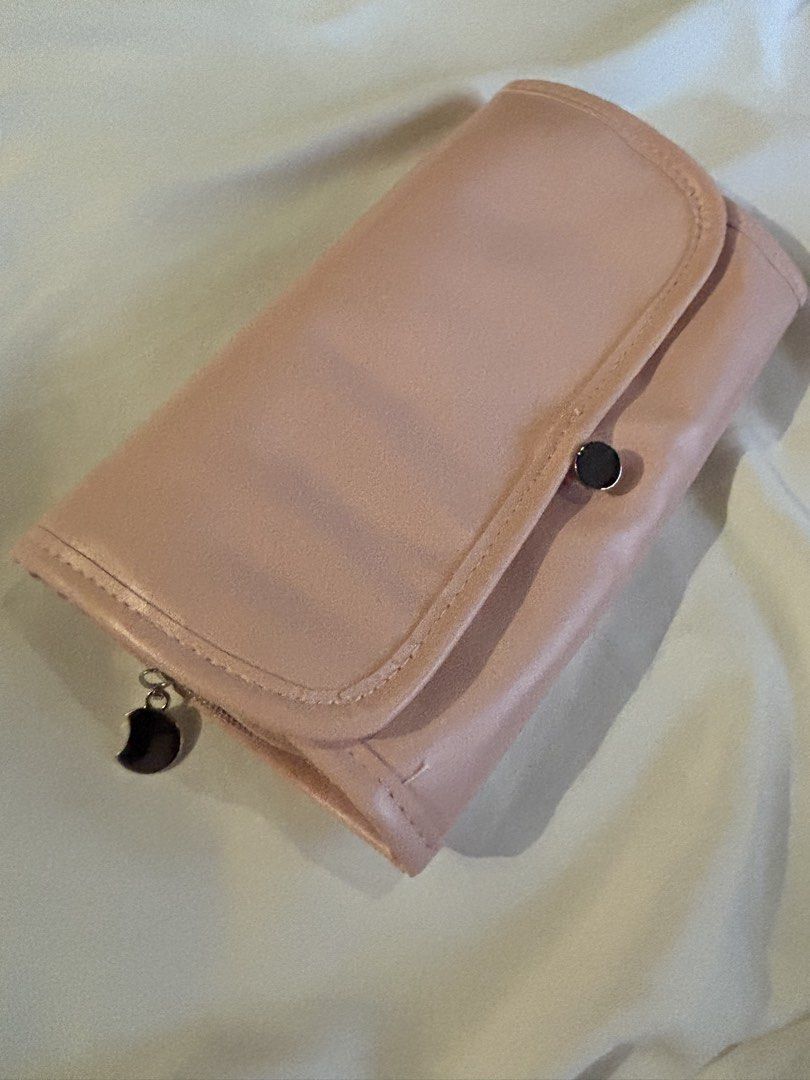 Pink Makeup Brush Organizer (Category: Makeup) located in Makati City. Submitted by makeupismyart (Listing ID 1431384973, Image 2). Description: - Brand new/ have not been used at all - Pink makeup brush organizer - Multiple slots for brushes - Zippered compartment for extra storage - Clear pocket for small items - Folds up for portability - Secure snap closure - Ideal for organizing and protecting your brushes.