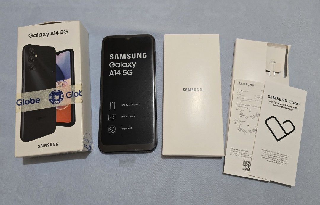 Samsung Galaxy A14 5G (Category: Samsung) located in Quezon City. Submitted by rachelleee_ (Listing ID 1431415208, Image 1). Description: Samsung Galaxy A14 5G Display: 6.6-inch PLS LCD Camera (Rear): 50MP main (f/1.8), 2MP macro (f/2.4), 2MP depth (f/2.4) Camera (Front): 13MP (f/2.0) Battery: 5000 mAh Storage & Memory: 128GB ROM, 6GB RAM (supports MicroSD up to 1TB) OS: Android 13, One UI Core 5 Features: Side-mounted fingerprint sensor, 5G conn
