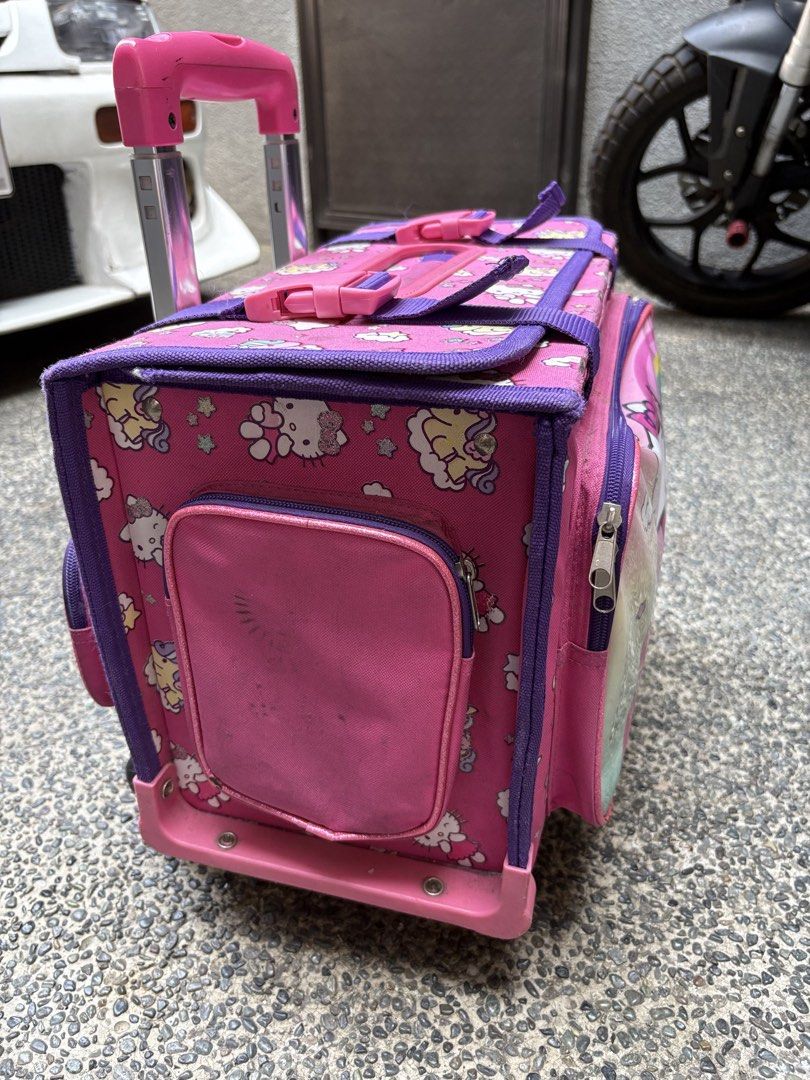 School Trolley Bag (Category: Backpacks) located in Marikina City. Submitted by igmtsisters (Listing ID 1431378511, Image 3). Description: Needs Cleaning‼️ 6 Wheels, Handles, Zippers are in good working condition‼️ Hello Kitty Box type Rotates 360 degrees Heavy-duty, box-like main compartment to prevent books from bending Inside Width 14” Length 10” RFS: Moving up- transition to back pack. .