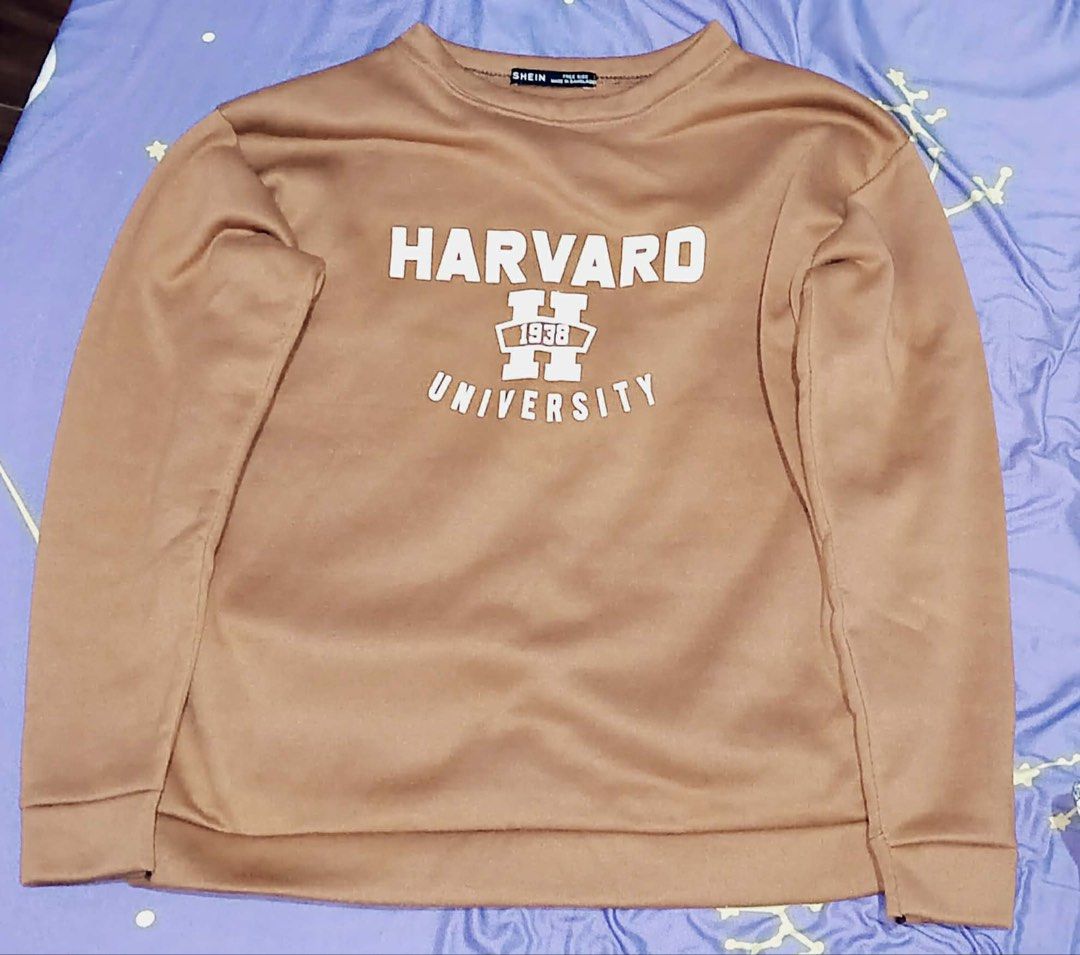 Shein Harvard University Sweatshirt (Category: Longsleeves) located in Manila. Submitted by mdph_ (Listing ID 1431411162, Image 1). Description: - Shein Harvard University sweatshirt - Brown color - Crew neck - Long sleeves - Soft, comfortable material - Perfect for casual wear - Size tag shown in photos.