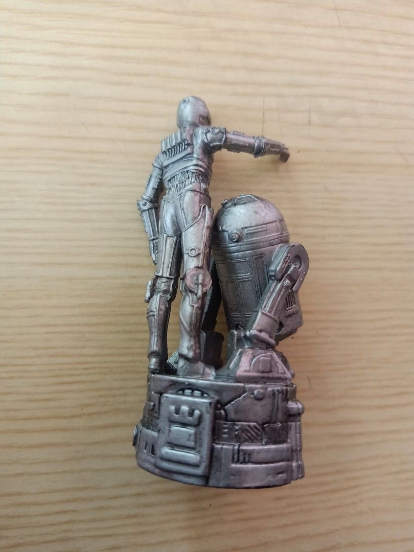 Star Wars C-3PO and R2-D2 Figurine (Category: Figurines & Statues) located in Las Pinas. Submitted by the_recycle_shop (Listing ID 1431402990, Image 2). Description: Figurine features C-3PO and R2-D2 from Star Wars. The base is marked with "© 2005 LFL". The figurine is silver in color. It depicts C-3PO with his arm raised and R2-D2 beside him. The back of the figurine shows the details of C-3PO and R2-D2. The base has intricate details..