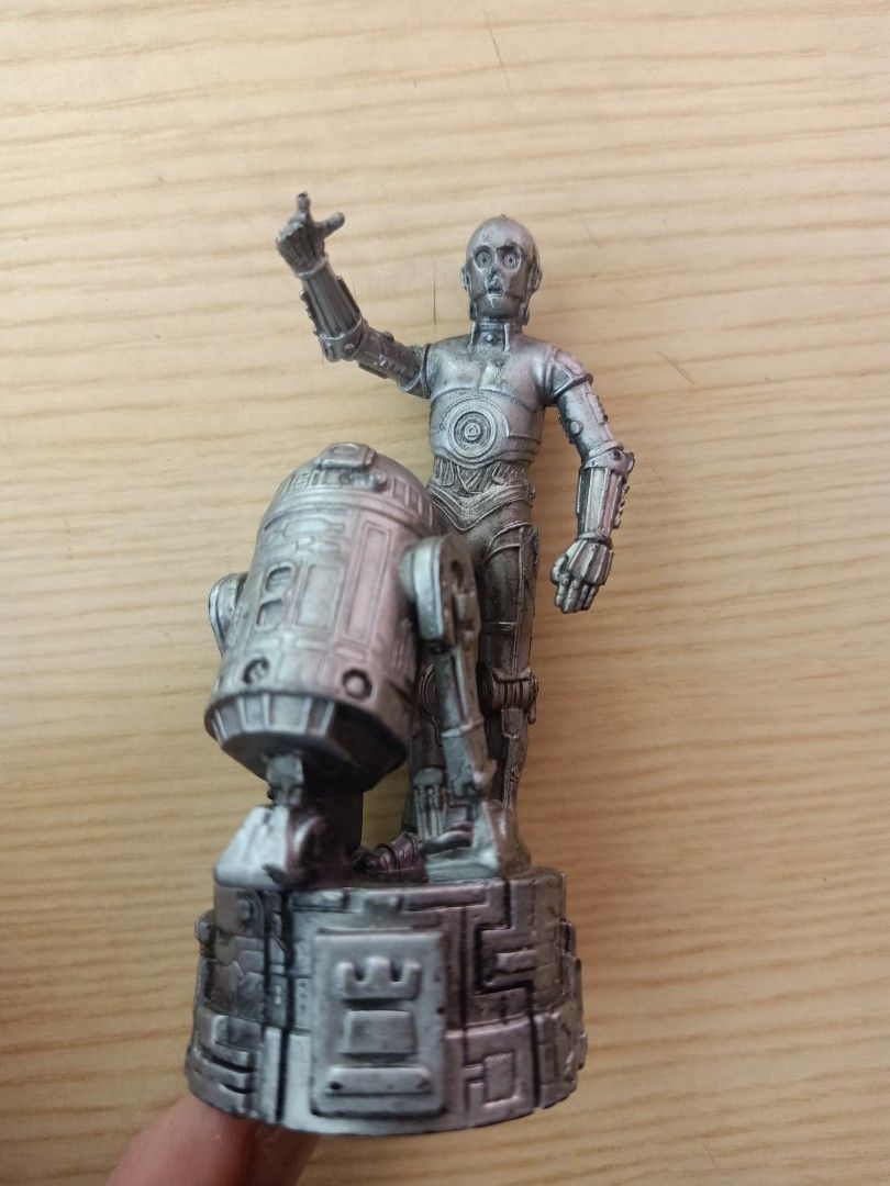 Star Wars C-3PO and R2-D2 Figurine (Category: Figurines & Statues) located in Las Pinas. Submitted by the_recycle_shop (Listing ID 1431402990, Image 1). Description: Figurine features C-3PO and R2-D2 from Star Wars. The base is marked with "© 2005 LFL". The figurine is silver in color. It depicts C-3PO with his arm raised and R2-D2 beside him. The back of the figurine shows the details of C-3PO and R2-D2. The base has intricate details..
