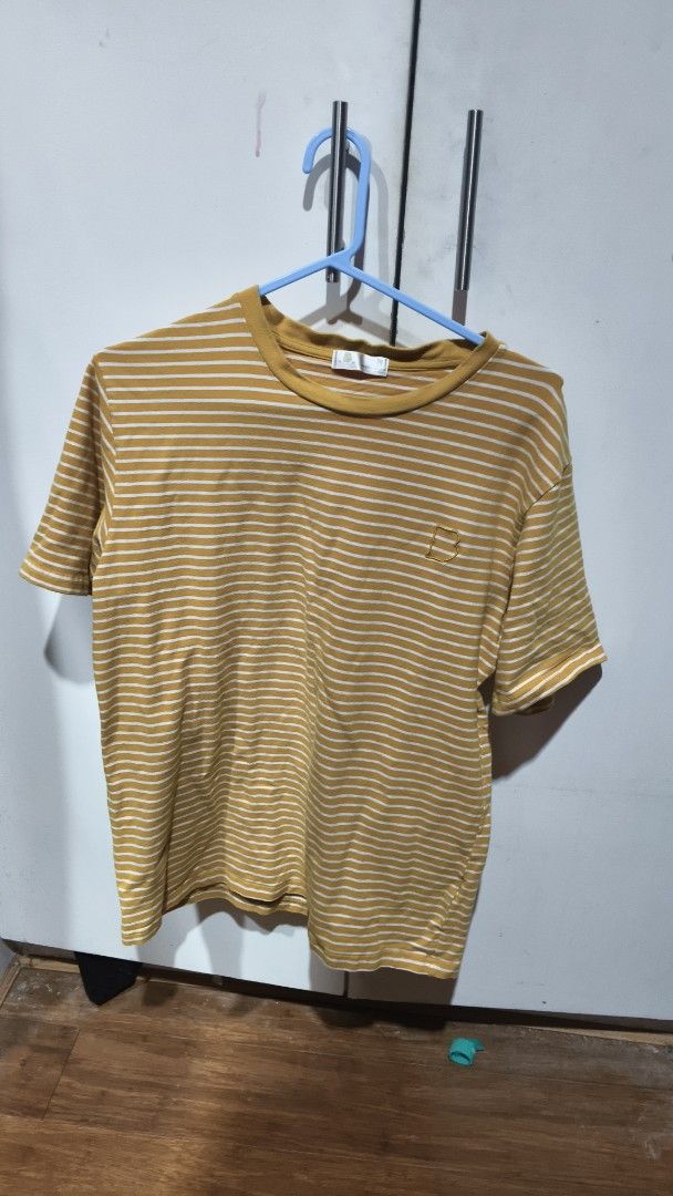 Striped T-shirt (Category: Tshirts & Polo Shirts ) located in Manila. Submitted by cmjunks (Listing ID 1431425279, Image 1). Description: - Mustard yellow striped t-shirt - Round neckline - Short sleeves - Small logo on the chest - Lightweight fabric - Ideal for casual wear.