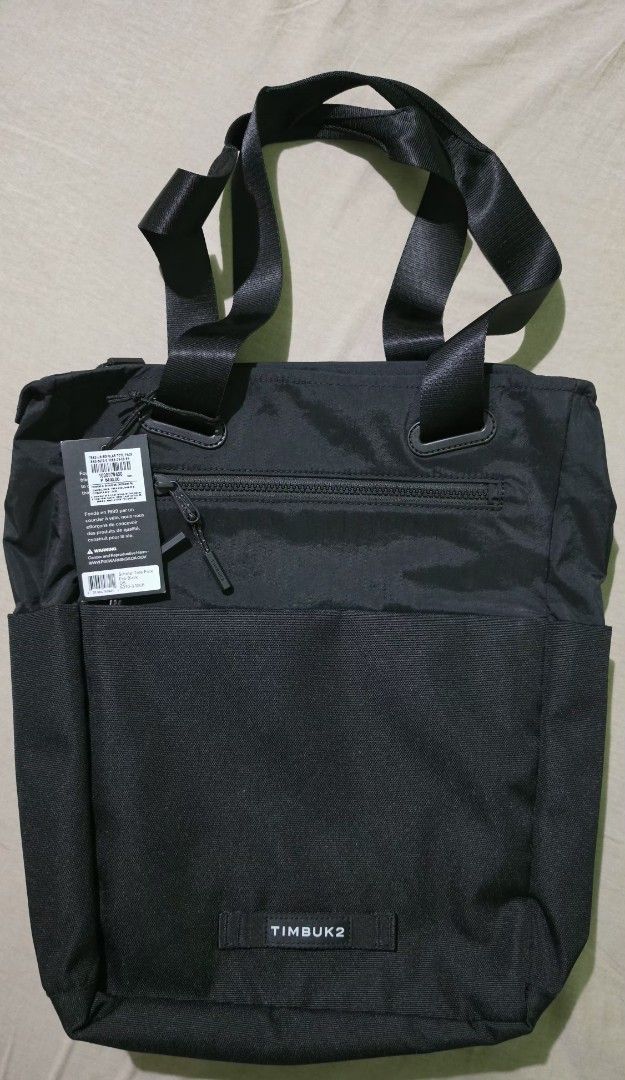 Timbuk2 Scholar Tote Pack Eco Black (Category: Tote Bags) located in Binmaley. Submitted by jner_122 (Listing ID 1431516485, Image 1). Description: - Timbuk2 Scholar Tote Pack - Color: Black -Internal slip pocket fits up to a 13'' laptop -Adjustable and tuckable backpack straps -Two front zip pockets for wallet, keys, and other small items -Dual side pockets fit water bottle, umbrella or mini U-lock -Anti-authority pocket - Zippered main compartm