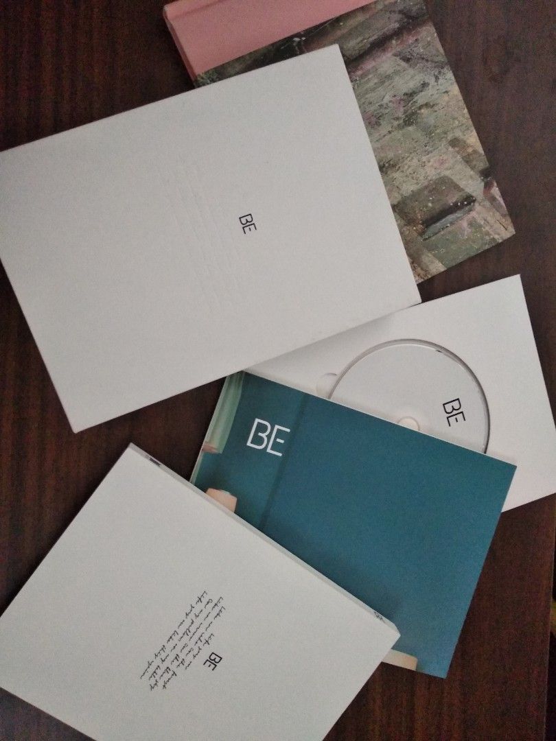 UNSEALED BTS BE album (Category: K-Wave Merchandise) located in Las Pinas. Submitted by tidywhys (Listing ID 1431440756, Image 2). Description: UNSEALED BTS BE Album with photo cards, poster, lyric book, CD. Album bottom seal is damaged (need glue) but overall such in good condition. Hard let go. rfs: quitting merch collection & need funds.