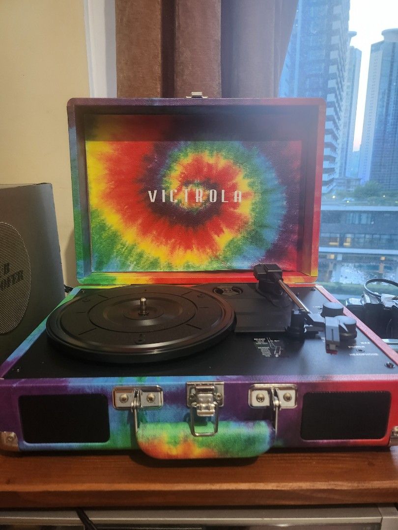 Victrola Suitcase Record Player (Turntable) (Category: Portable Music Players) located in Taguig. Submitted by sellout2ny (Listing ID 1431548353, Image 1). Description: Victrola turntable 3800 pesos - Built in speakers - Eye-catching tie-dye design - Portable suitcase style with handle and metal clasps - Can connect to external speakers.