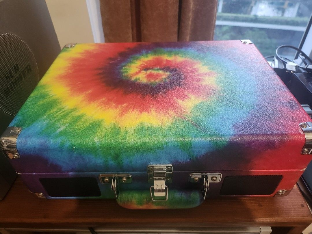 Victrola Suitcase Record Player (Turntable) (Category: Portable Music Players) located in Taguig. Submitted by sellout2ny (Listing ID 1431548353, Image 2). Description: Victrola turntable 3800 pesos - Built in speakers - Eye-catching tie-dye design - Portable suitcase style with handle and metal clasps - Can connect to external speakers.