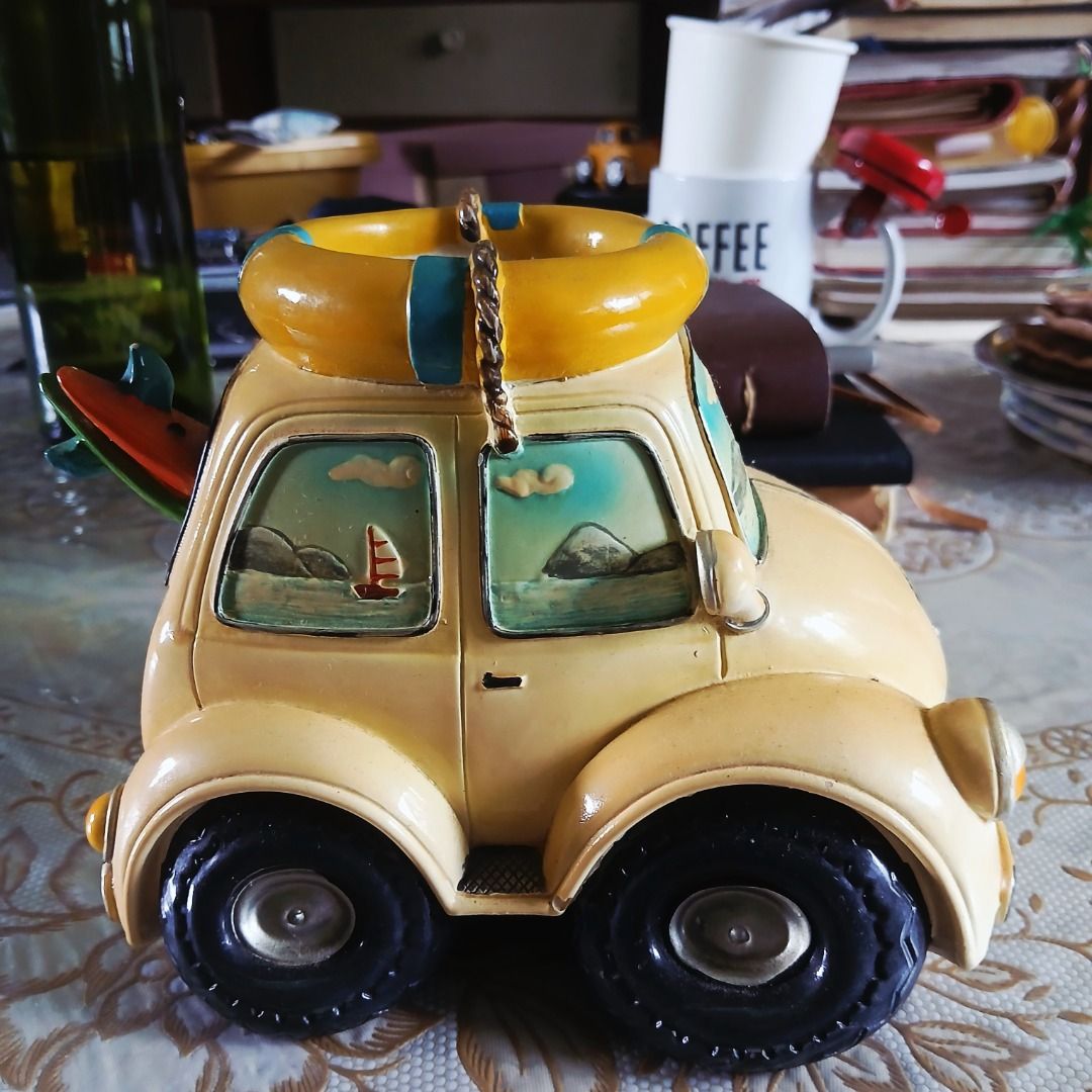 Vintage VW Beetle Figurine with Surfboards (Category: Vehicle & Diecast Models) located in Pasig City. Submitted by arlafontam89410 (Listing ID 1431395690, Image 1). Description: Surfy Yellow Volkswagen Beetle Model w/Surfboard & Lifebuoy Beach Theme This is a collectible ceramic collectible perfect for Volkswagen Beetles or beach enthusiasts. This classic vehicle features a well-loved yellow VW Bug and is adorned with surfing-themed accessories 