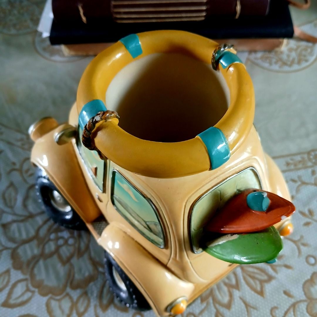 Vintage VW Beetle Figurine with Surfboards (Category: Vehicle & Diecast Models) located in Pasig City. Submitted by arlafontam89410 (Listing ID 1431395690, Image 3). Description: Surfy Yellow Volkswagen Beetle Model w/Surfboard & Lifebuoy Beach Theme This is a collectible ceramic collectible perfect for Volkswagen Beetles or beach enthusiasts. This classic vehicle features a well-loved yellow VW Bug and is adorned with surfing-themed accessories 