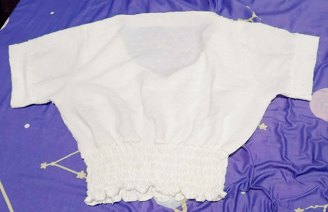 White blouse (Category: Sleeveless) located in Manila. Submitted by mdph_ (Listing ID 1431412412, Image 1). Description: - White V-neck top - Short sleeves - Smocked waist for a flattering fit - Textured fabric - Versatile style - Perfect with high-waisted bottoms.