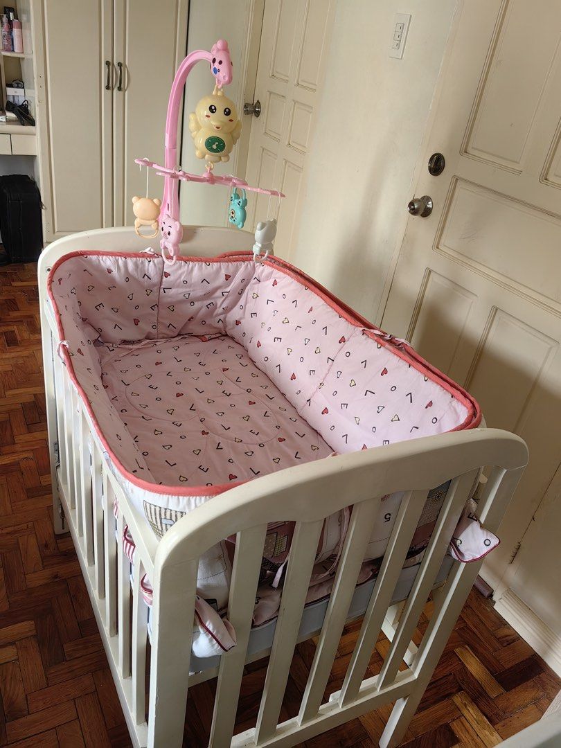 Wooden crib (Category: Cots & Cribs) located in Santa Rosa. Submitted by momjell (Listing ID 1431514559, Image 1). Description: White Wooden Crib Foldable & Adjustable Used but not abused and still functional Original Price: ₱6,000 customized With FREE mattress, comforter, bumper pads & hanging mobile toy.