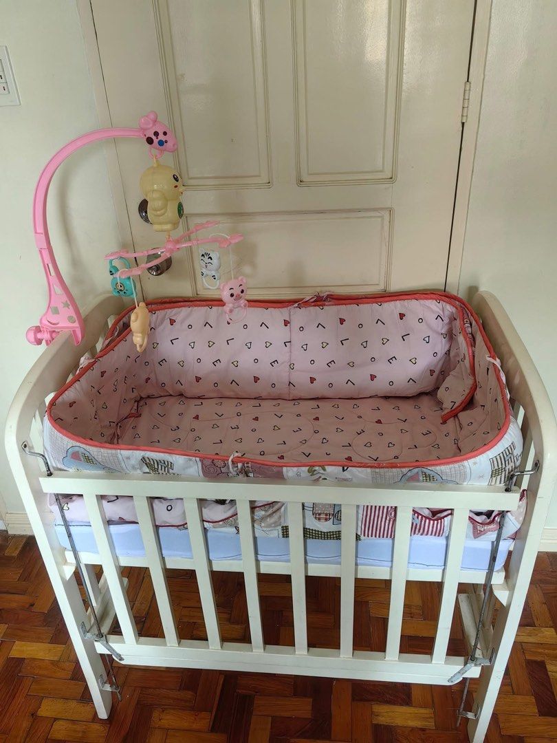 Wooden crib (Category: Cots & Cribs) located in Santa Rosa. Submitted by momjell (Listing ID 1431514559, Image 2). Description: White Wooden Crib Foldable & Adjustable Used but not abused and still functional Original Price: ₱6,000 customized With FREE mattress, comforter, bumper pads & hanging mobile toy.