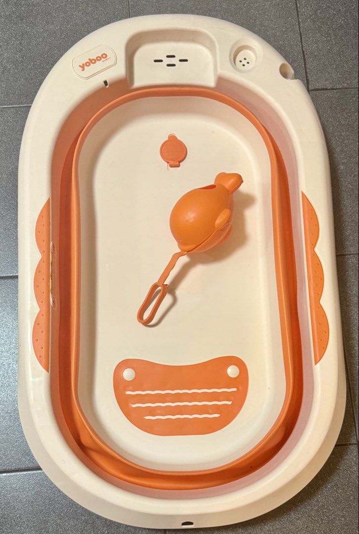 Yoboo Foldable Baby Bathtub (Category: Bathtub & Bath Accessories) located in Quezon City. Submitted by kryshnanzyanna (Listing ID 1431533375, Image 2). Description: - Yoboo foldable baby bathtub - Color: Orange and white - Includes whale-shaped water scoop - Folds flat for easy storage - Perfect for travel.