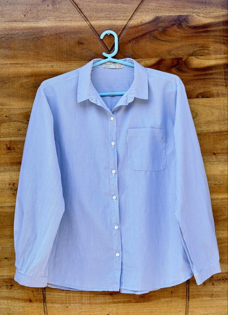Zara Kids Striped Long Sleeves (Category: Babies & Kids Fashion) located in Cavite. Submitted by peppermintsss (Listing ID 1431435307, Image 1). Description: - Zara Kids striped shirt - Features a chest pocket - Classic collar and button-down closure - Color: Blue and white stripes with yellow side stripes - Size: 13/14 (164cm) - Made in Morocco ‼️Bust: 20” ‼️ Length: 24” 🛵 SF will be shouldered by the buyer.
