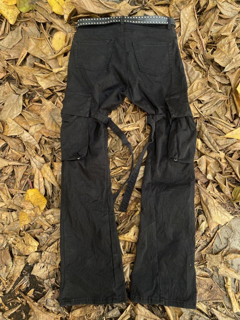 Archive Vuja De 2019 Bondage Flare Cargo Pants (Category: Jeans) located in Iligan City. Submitted by trickorthrift1 (Listing ID 1431642865, Image 2). Description: Rare 2019 release from Vuja De, featuring their signature bondage-inspired detailing and modern flare silhouette. These black cargo pants showcase a clean yet utilitarian aesthetic, equipped with multiple functional pockets and adjustable strap elements that give it a distinct techwear