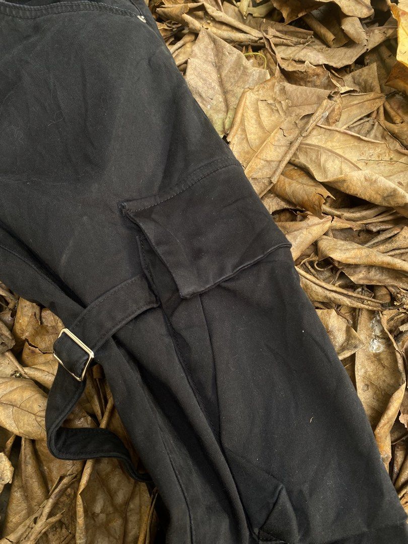Archive Vuja De 2019 Bondage Flare Cargo Pants (Category: Jeans) located in Iligan City. Submitted by trickorthrift1 (Listing ID 1431642865, Image 3). Description: Rare 2019 release from Vuja De, featuring their signature bondage-inspired detailing and modern flare silhouette. These black cargo pants showcase a clean yet utilitarian aesthetic, equipped with multiple functional pockets and adjustable strap elements that give it a distinct techwear