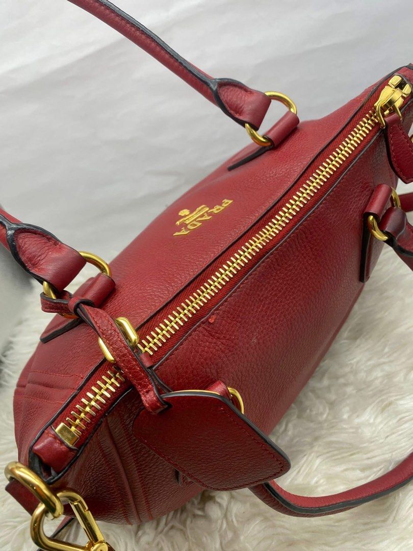 Authentic Prada Vitello Phenix 2-Way Bag (Category: Luxury Bags & Wallets) located in Quezon City. Submitted by arleeeneb (Listing ID 1431592574, Image 3). Description: Material: Grained Calfskin Leather (Vitello Phenix) • Hardware: Polished Gold-tone • Color: Red / Rosso • Condition: 9/10. Hardware is still bright, leather is supple with very minimal signs of wear. • Inclusions: Comes with detachable/adjustable shoulder strap and name tag..
